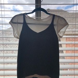 white tee layered with a black silver material.